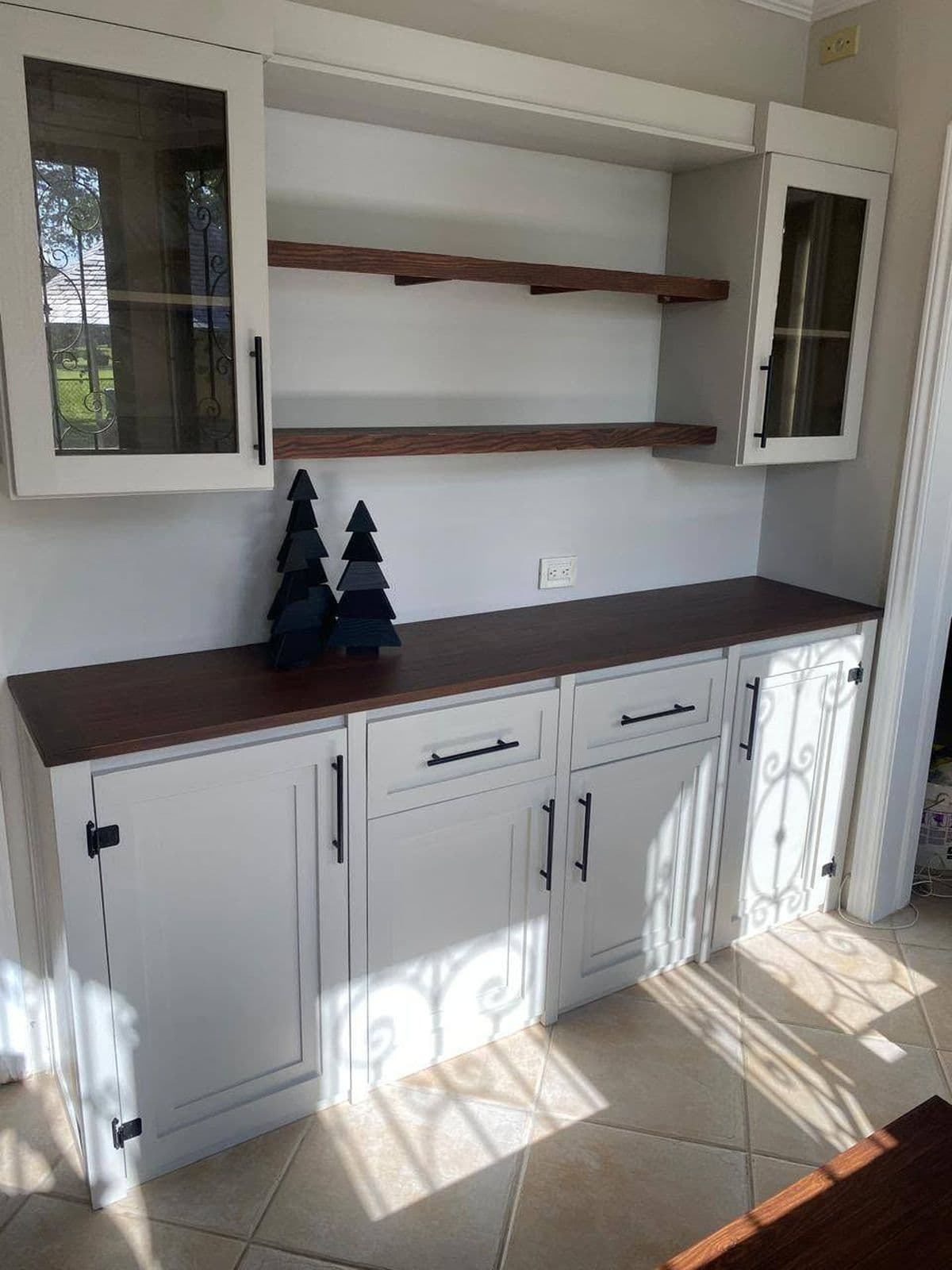 Built-in pantry hutch with glass-front cabinets, walnut countertop and floating walnut shelves